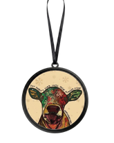 Round Christmas ornament featuring a colorful illustrated cow with a black hanging ribbon, shown on a plain white background.